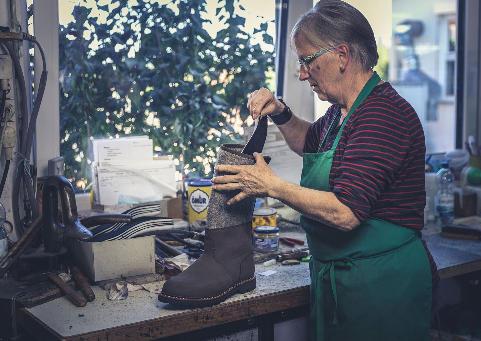 Lydia placing a footbed in double-stitched hiking boots