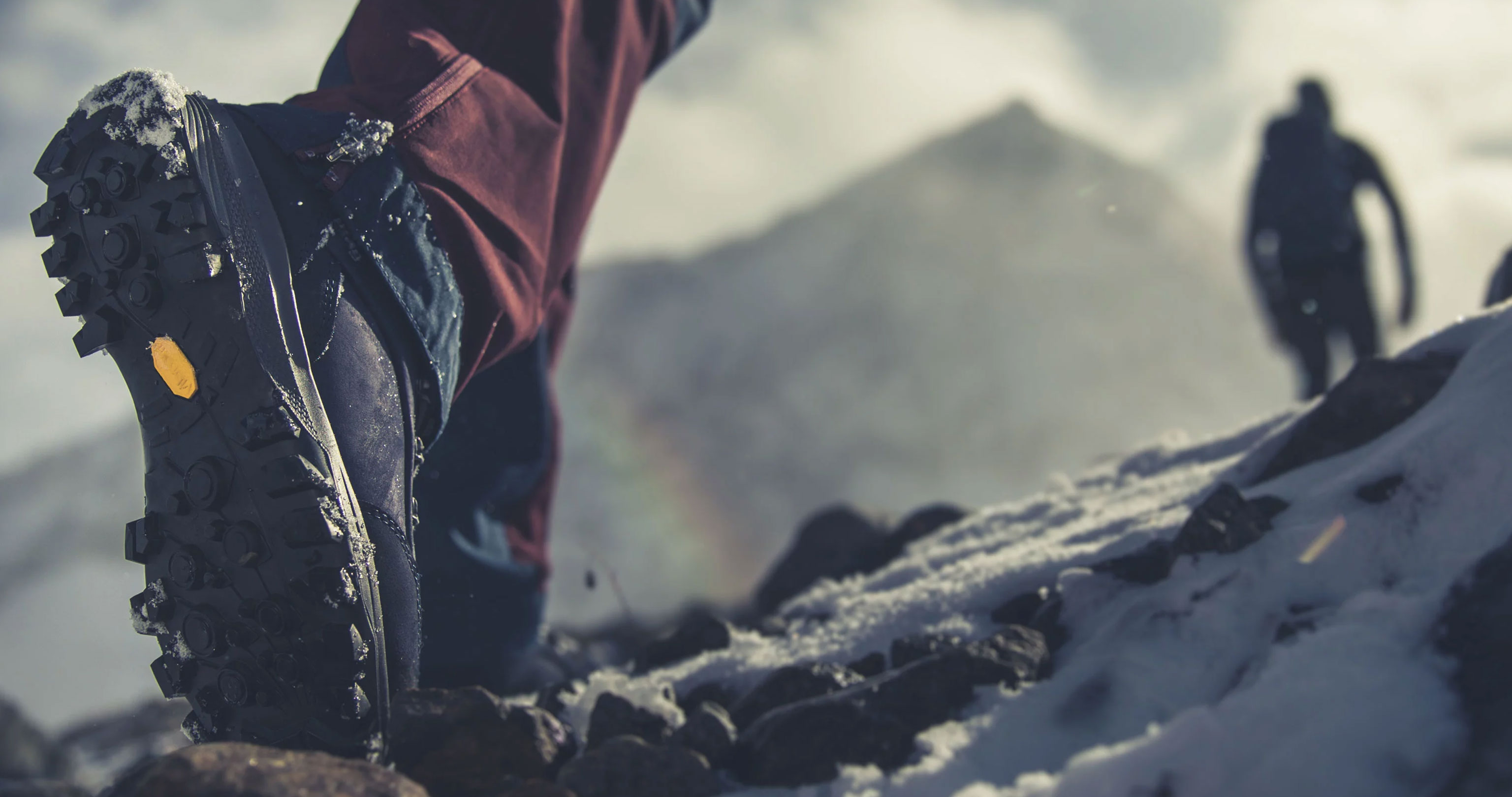 Hiking boots with Vibram soles in winter conditions in the mountains