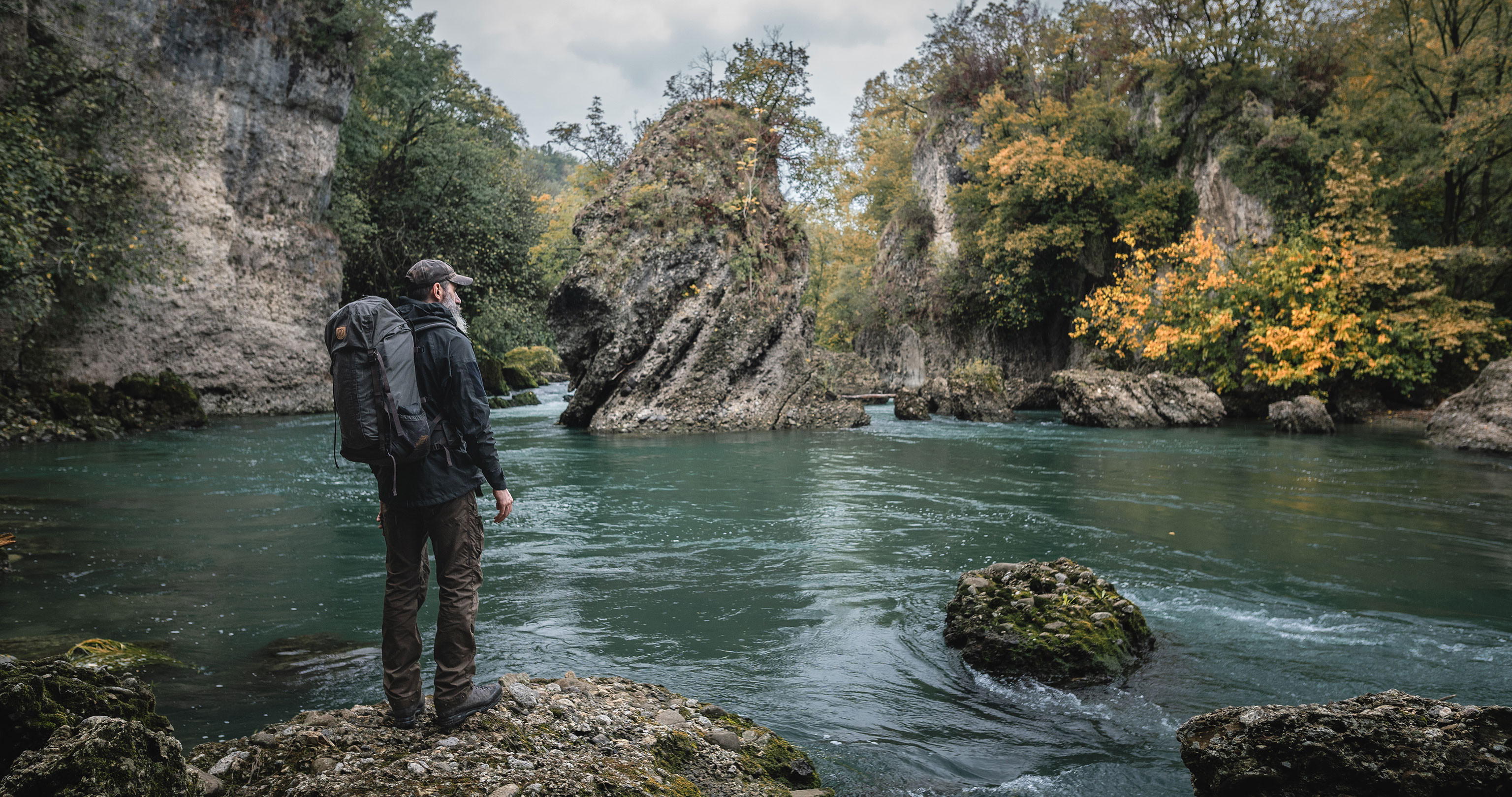 Bushcraft guide expert Alex Wander standing at a river