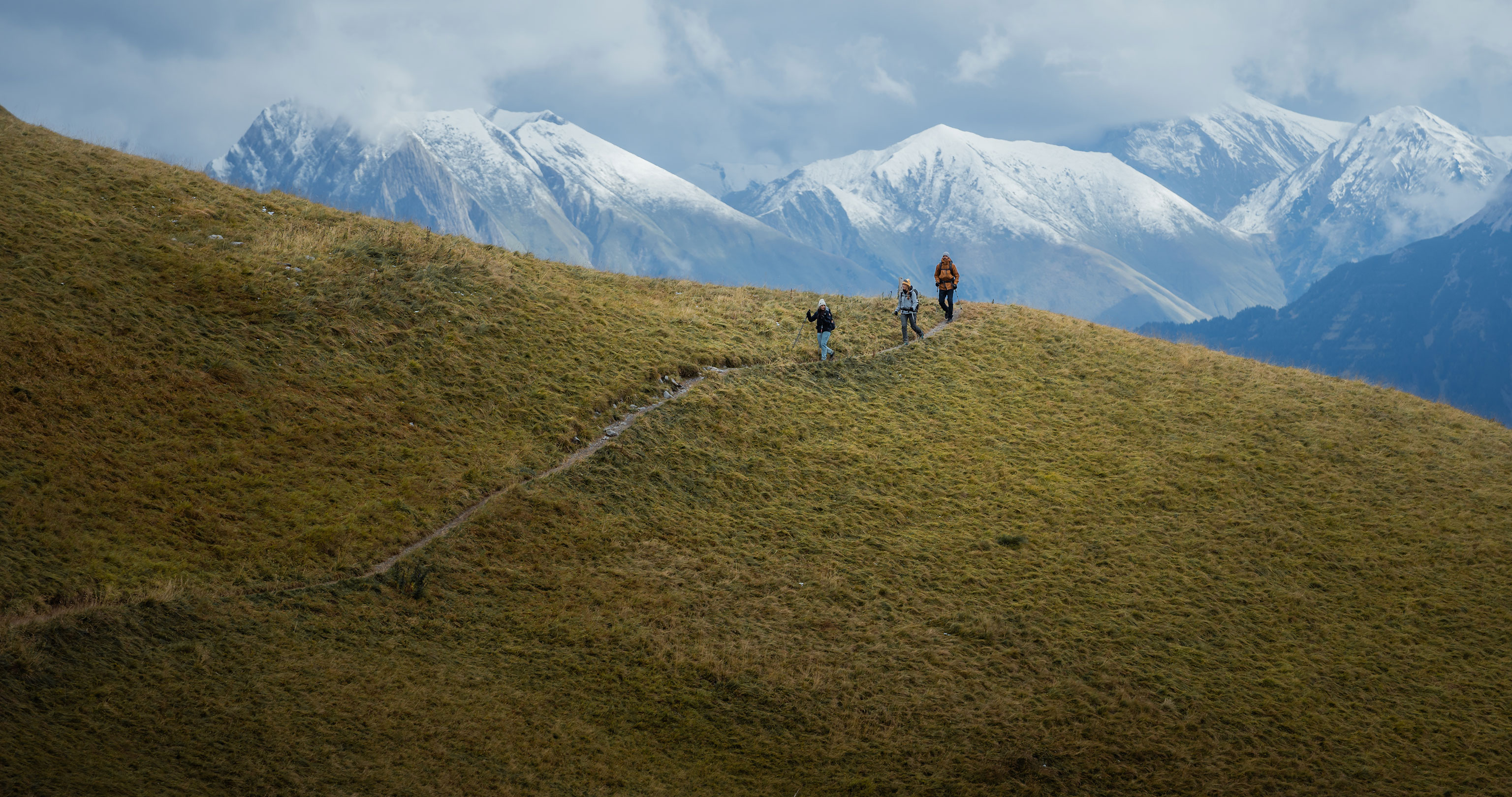 Three hikers in the Alps