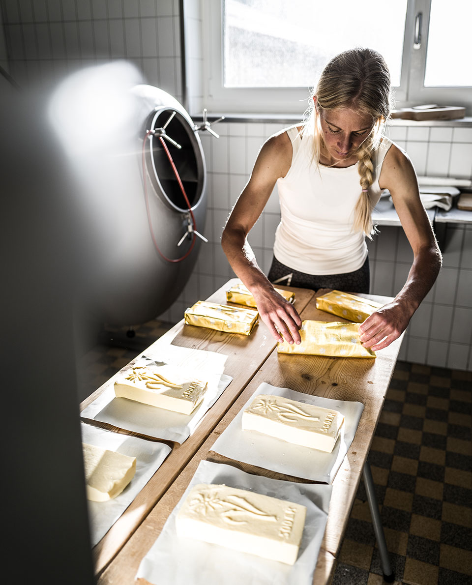 Katharina packing butter on a long table